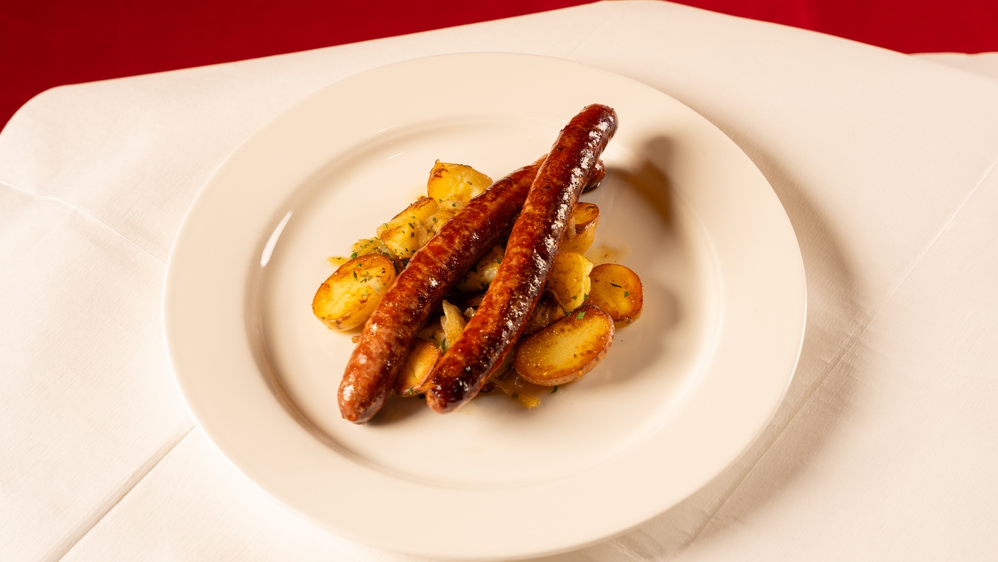 Merguez sausages, Lyonnaise potatoes, roasting juice